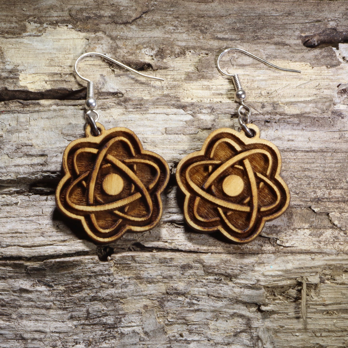 Handcrafted atom wooden dangle earrings featuring a classic atomic model with orbiting electrons. Lightweight laser-cut wooden earrings with hypoallergenic .925 sterling silver hooks, perfect for scientists, chemistry teachers, physics students, STEM enthusiasts, laboratory professionals, and science lovers.