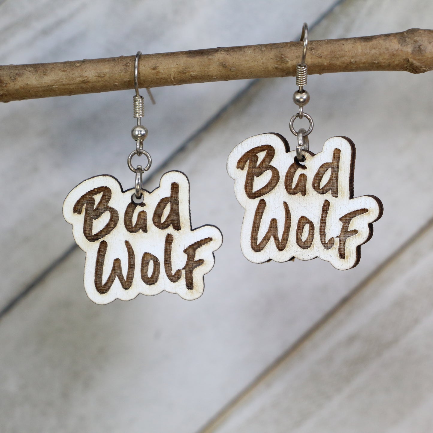 Hand-painted wooden Bad Wolf dangle earrings with sci-fi phrase design and hypoallergenic sterling silver hooks, lightweight fandom statement jewelry earrings for time travel and space lovers