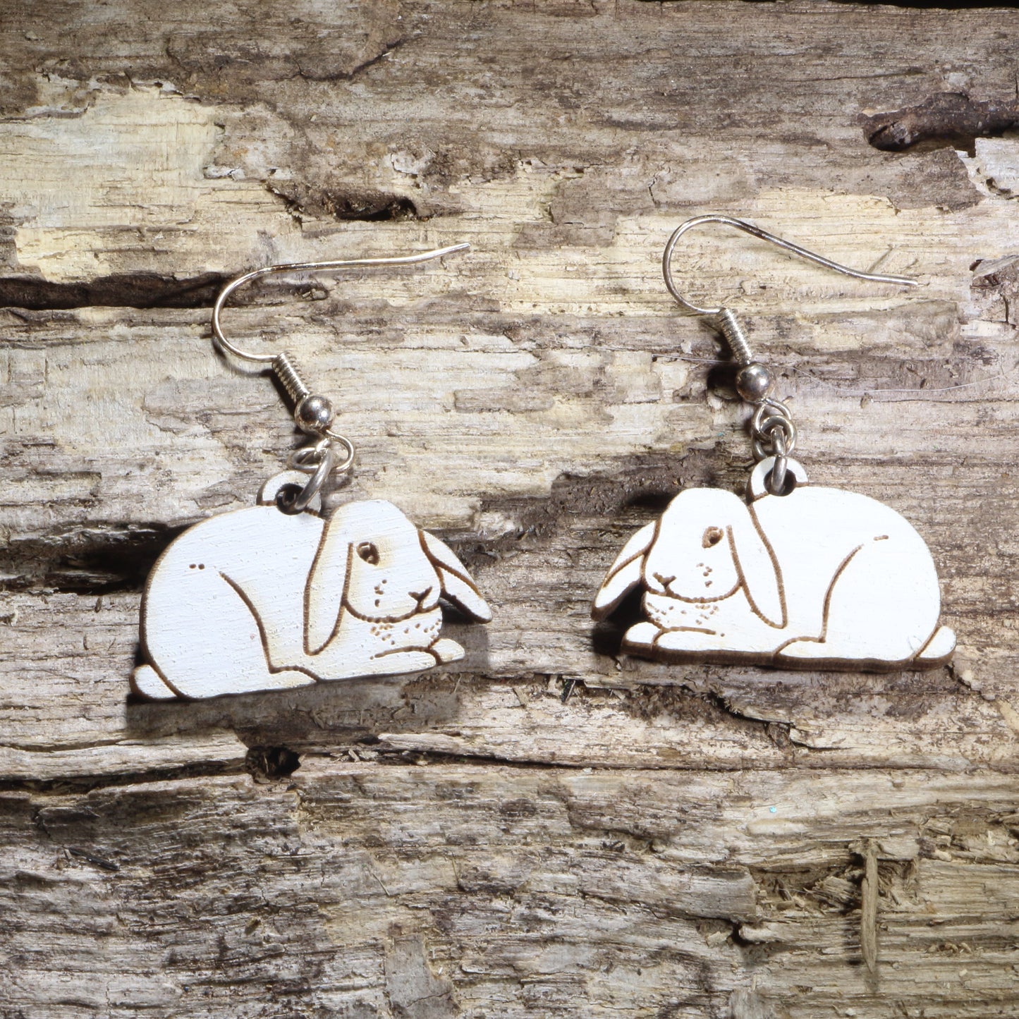 Handcrafted Holland Lop rabbit wooden dangle earrings featuring adorable floppy-eared bunny designs with hand-painted details. Lightweight laser-cut wooden earrings with hypoallergenic .925 sterling silver hooks, perfect for Holland Lop owners, rabbit lovers, bunny enthusiasts, pet parents, and unique handmade animal jewelry.