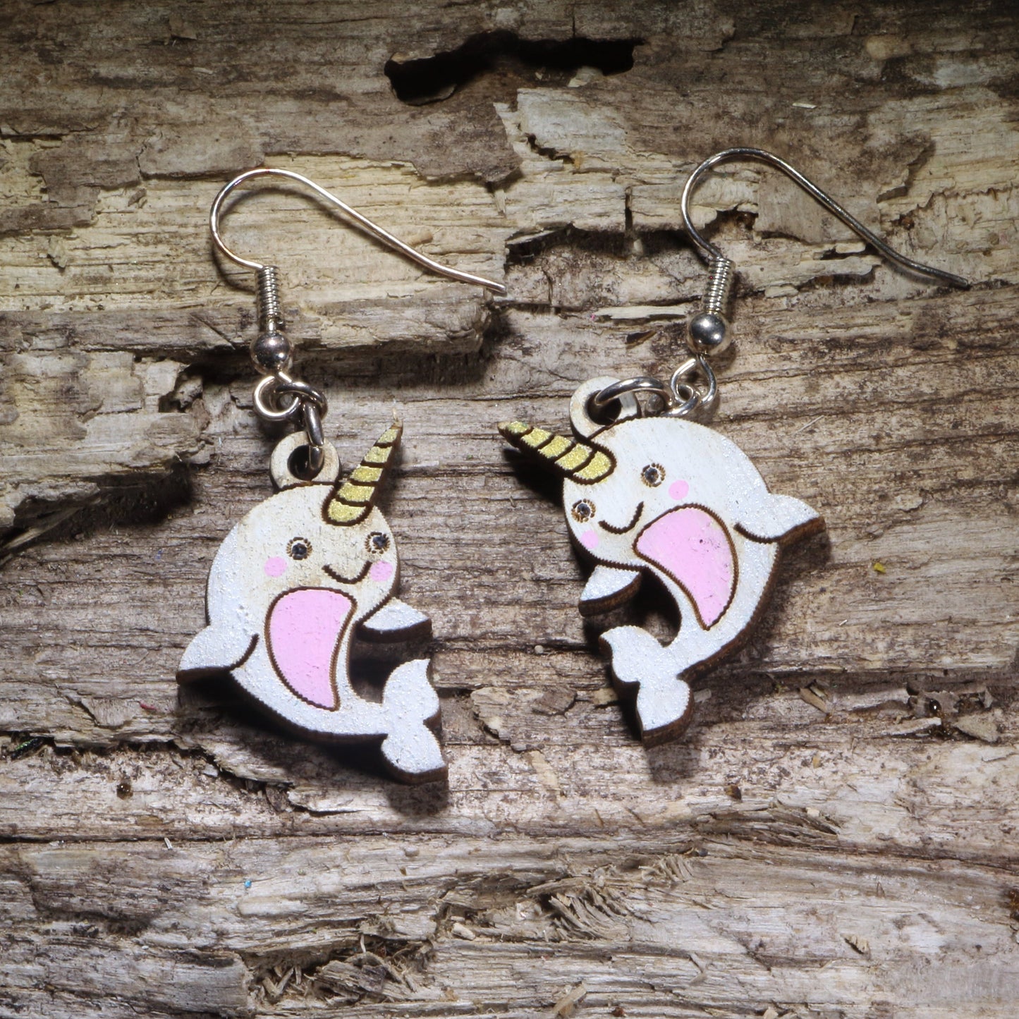 Kawaii narwhal wooden dangle earrings featuring cute white narwhals with gold horns, pink bellies, rosy cheeks, and smiling faces. Hand-painted lightweight ocean earrings with hypoallergenic .925 sterling silver hooks, perfect for narwhal lovers, marine life fans, kawaii jewelry lovers, and whimsical ocean-themed gifts.