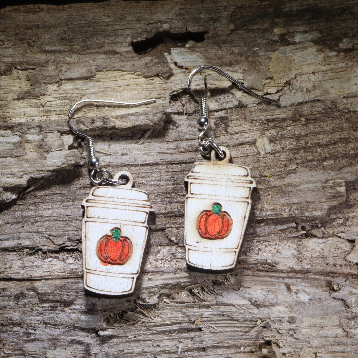 Pumpkin spice latte wooden dangle earrings featuring a hand-painted fall coffee cup with festive pumpkin details. Lightweight autumn earrings with hypoallergenic .925 sterling silver hooks, perfect for coffee lovers, pumpkin spice fans, baristas, fall festivals, cozy seasonal outfits, and autumn jewelry gifts.