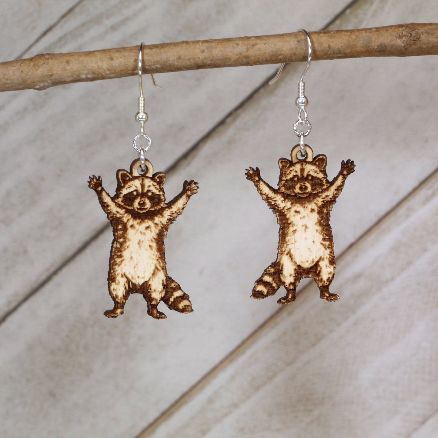 Hand-painted raccoon wooden dangle earrings with playful wildlife design, lightweight hypoallergenic animal jewelry for nature lovers, quirky fashion fans, and raccoon enthusiasts
