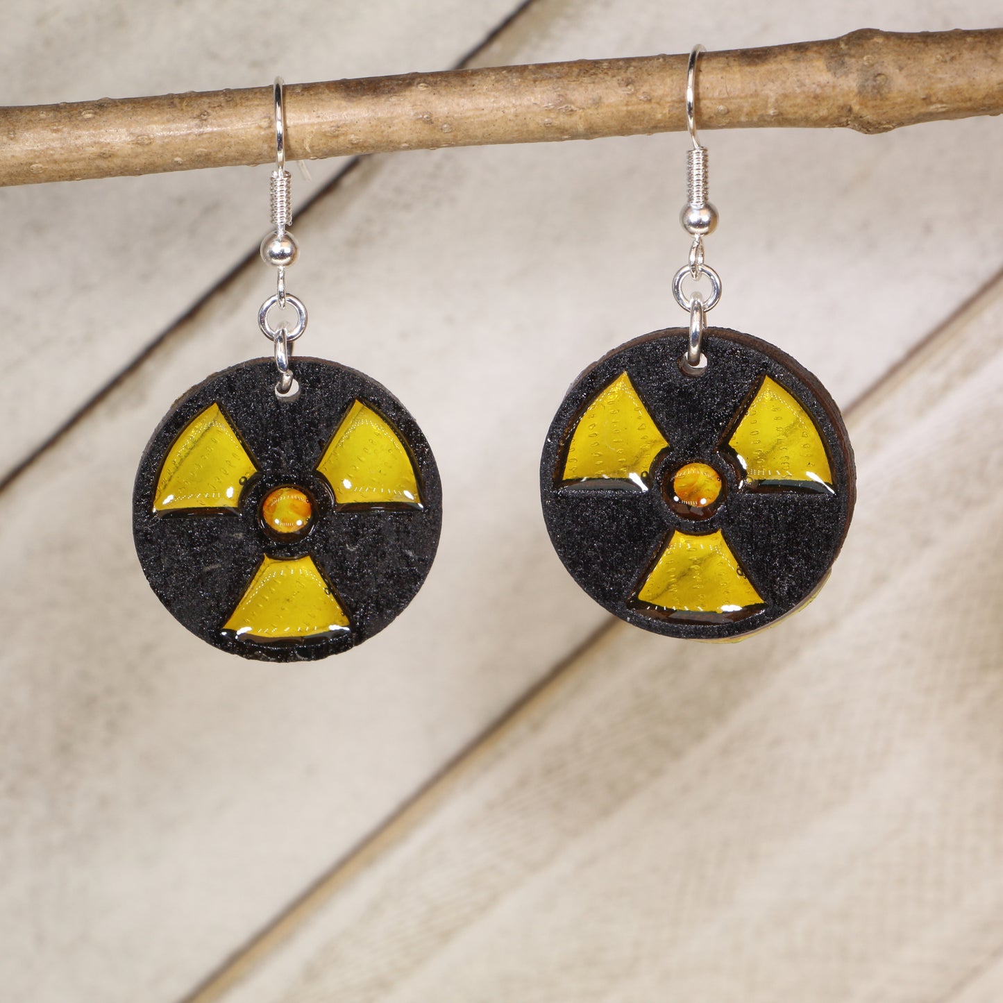 Hand-painted wooden radioactive symbol dangle earrings with bold nuclear hazard design and hypoallergenic sterling silver hooks, lightweight science geek statement jewelry for STEM lovers and edgy style