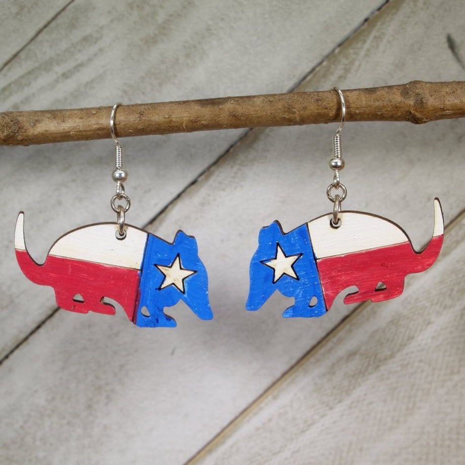 Hand-painted wooden Texas flag armadillo dangle earrings with Lone Star state pride design and hypoallergenic sterling silver hooks, lightweight Southern statement jewelry for Texas lovers and wildlife fans