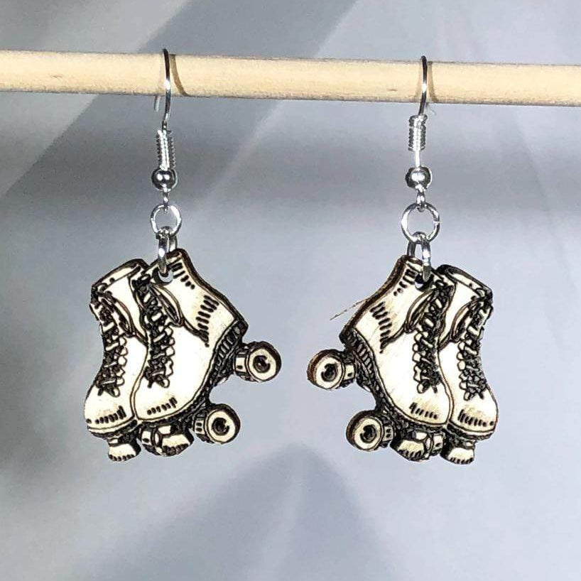 Hand-painted wooden roller derby skate dangle earrings featuring a retro quad skate design with wheels and lace details and hypoallergenic sterling silver hooks, lightweight jewelry for skaters and roller derby enthusiasts by Cate’s Concepts