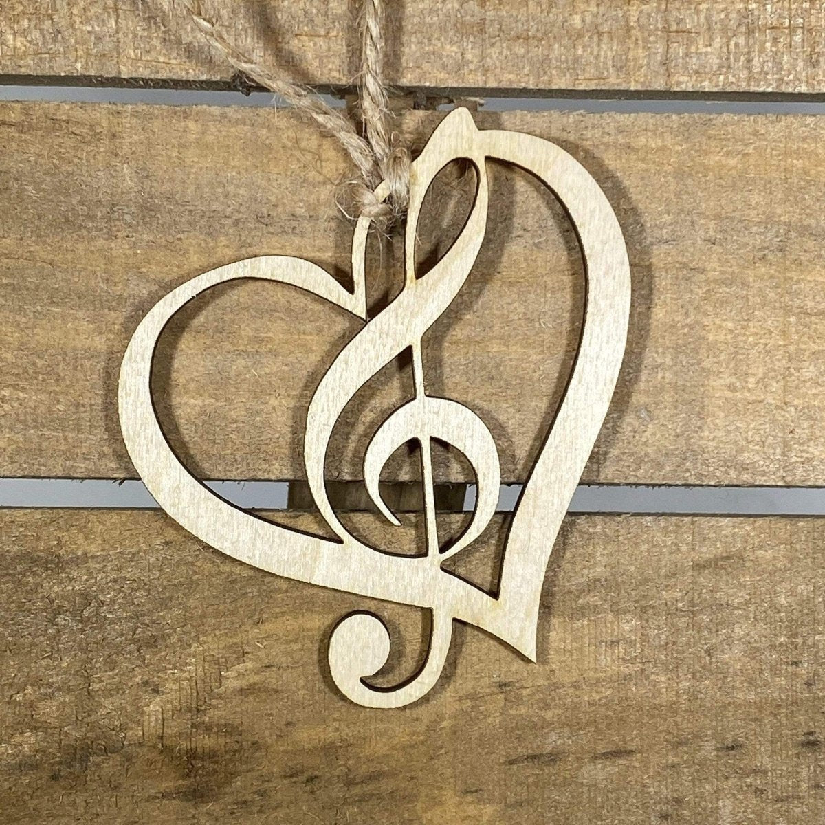 Hand-painted wooden heart treble clef Christmas ornament featuring a musical note shaped into a heart design with elegant curves, festive holiday decor for musicians and music lovers by Cate’s Concepts
