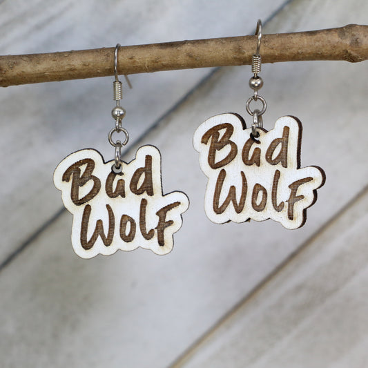 Hand-painted wooden Bad Wolf dangle earrings with sci-fi phrase design and hypoallergenic sterling silver hooks, lightweight fandom statement jewelry earrings for time travel and space lovers 
