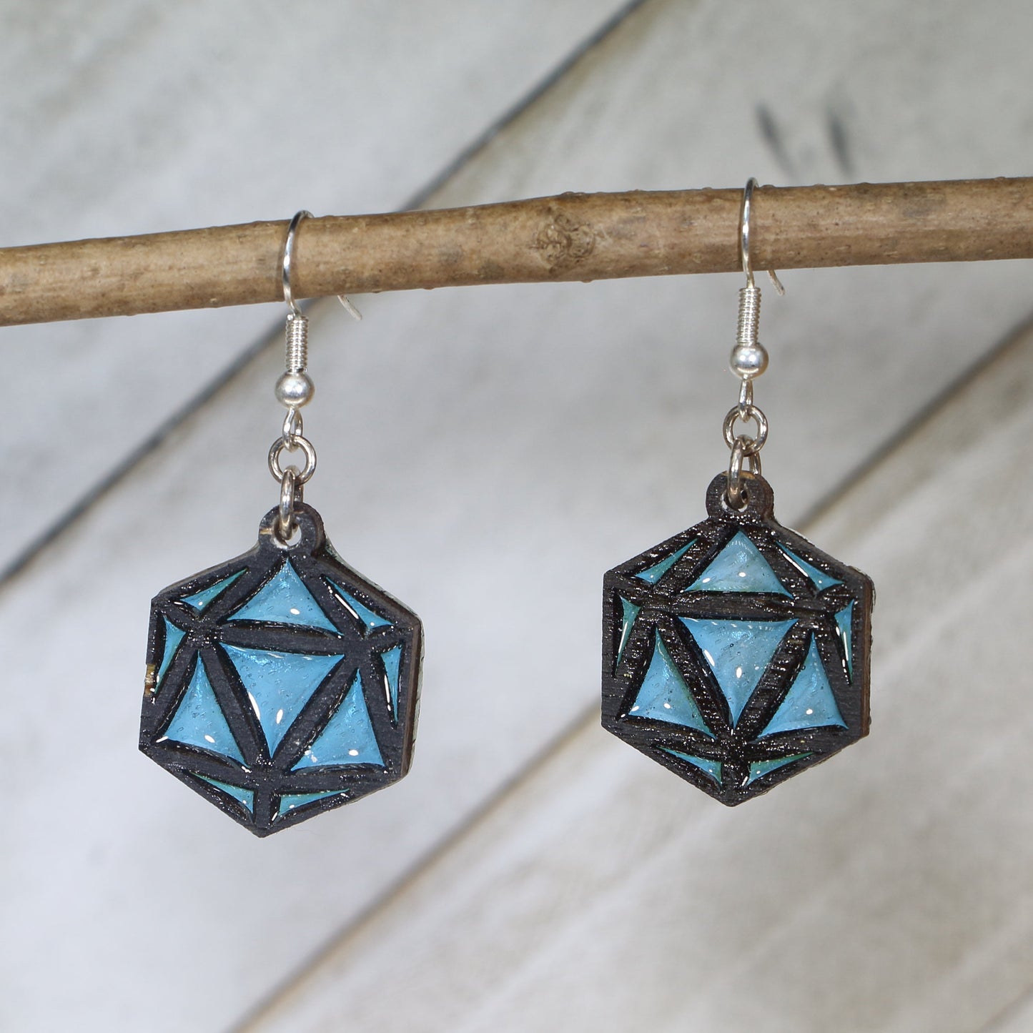 Hand-painted wooden blue D20 dangle earrings featuring a twenty-sided dice design with bold numbering and hypoallergenic sterling silver hooks, lightweight jewelry for tabletop gamers and Dungeons and Dragons fans