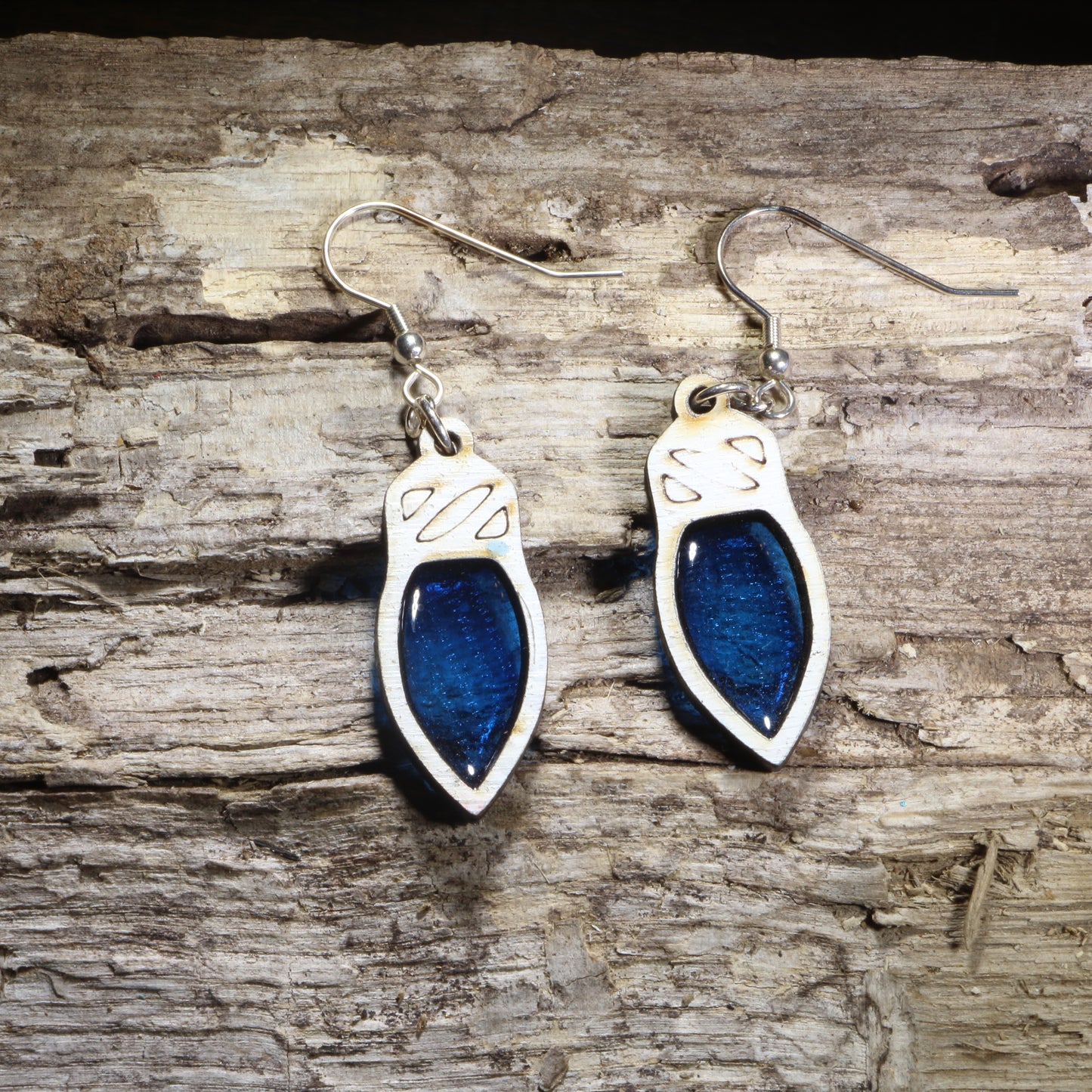 Handcrafted resin blue Christmas light wooden dangle earrings featuring colorful holiday light bulbs with glossy resin-filled centers. Lightweight laser-cut wooden earrings with hypoallergenic .925 sterling silver hooks, perfect for Christmas celebrations, holiday parties, festive fashion, Christmas light lovers, and seasonal handmade jewelry.