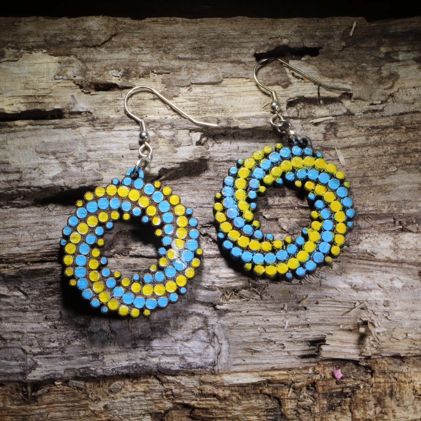 Blue Yellow and-painted colorful dot spiral wooden dangle earrings featuring a bold swirling pattern of colorful dots. Lightweight geometric statement earrings available in multiple color combinations, perfect for art lovers, colorful style, and playful modern outfits.