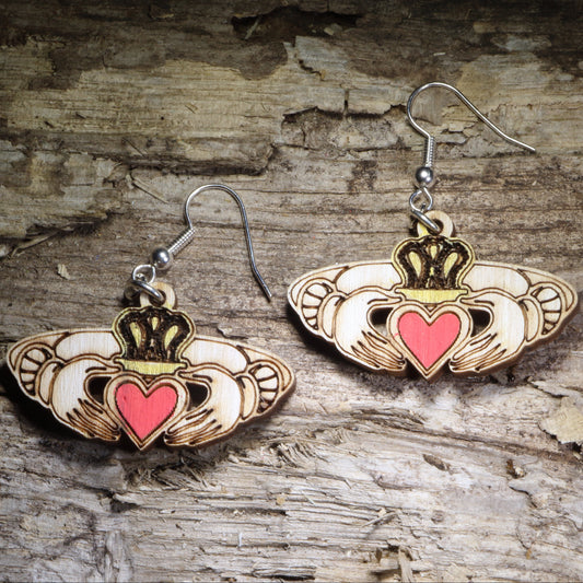 Claddagh wooden dangle earrings featuring the traditional Irish heart, hands, and crown symbol representing love, friendship, and loyalty. Hand-painted lightweight Celtic earrings with hypoallergenic .925 sterling silver hooks, perfect for Irish heritage gifts, Celtic jewelry lovers, St. Patrick’s Day, and meaningful symbolic jewelry.