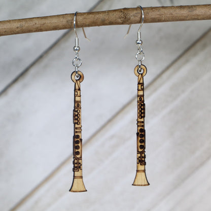 Hand-painted wooden clarinet dangle earrings featuring a detailed straight instrument design with keywork and mouthpiece accents and hypoallergenic sterling silver hooks, lightweight jewelry for band members and woodwind enthusiasts by Cate’s Concepts