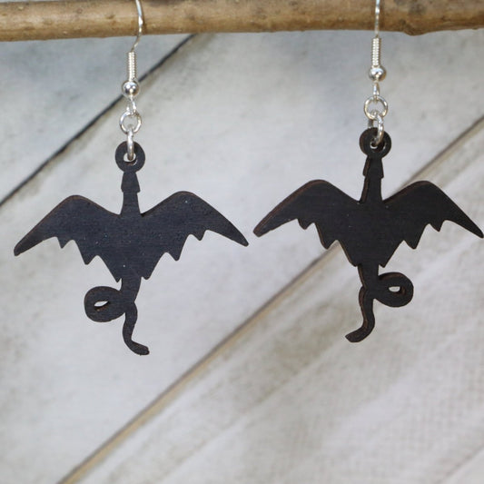 Hand-painted wooden dragon silhouette dangle earrings featuring a striking winged dragon design with sharp contours and flowing tail and hypoallergenic sterling silver hooks, lightweight jewelry for fantasy fans and mythical creature enthusiasts by Cate’s Concepts