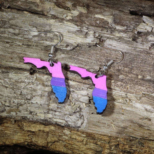 Hand-painted wooden Florida bisexual pride dangle earrings featuring the Florida state silhouette in pink, purple, and blue bisexual pride stripes, hypoallergenic sterling silver hooks, and lightweight LGBTQ+ state pride jewelry by Cate's Concepts.
