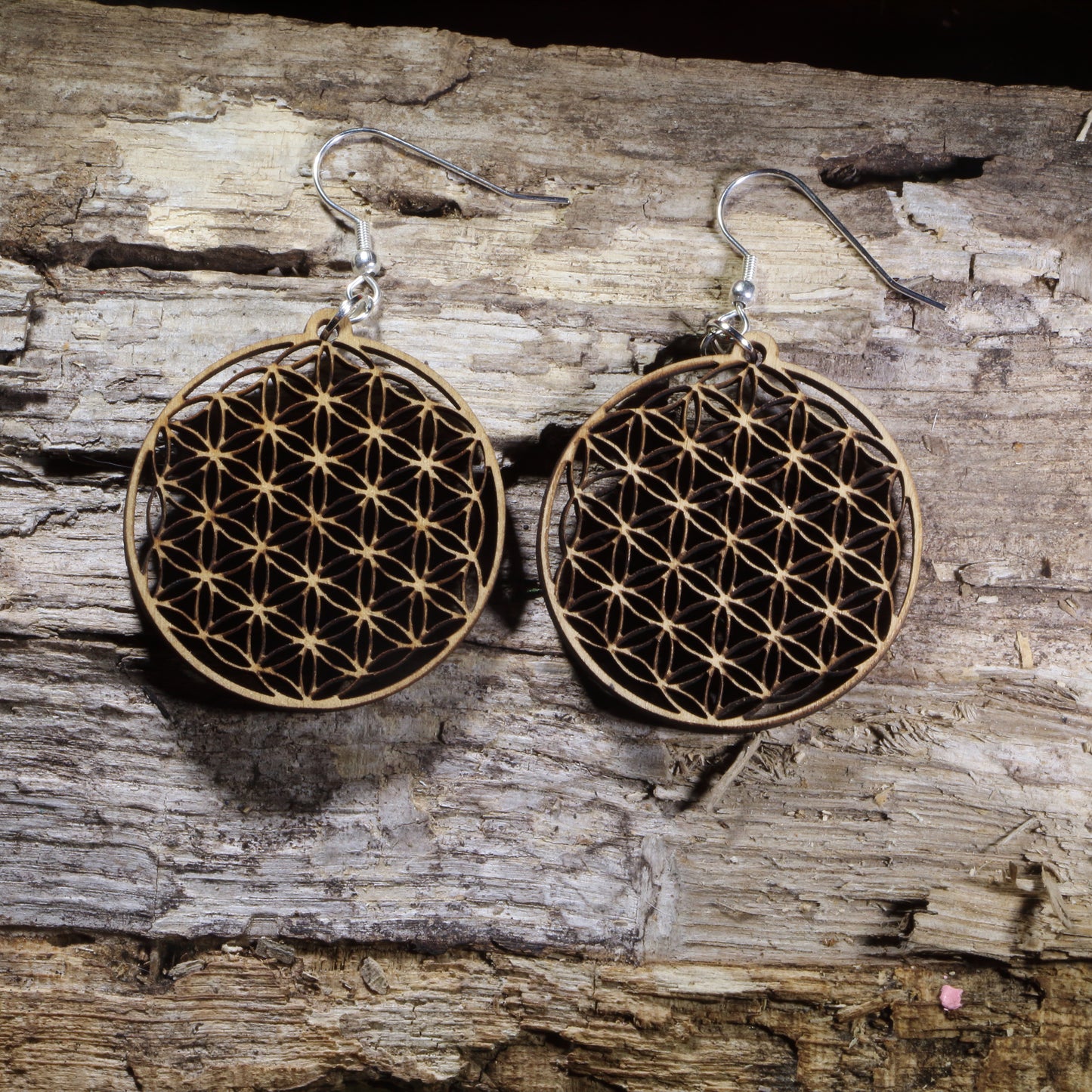 Handcrafted Flower of Life wooden dangle earrings featuring the sacred geometry symbol representing harmony, unity, and the interconnectedness of all life. Lightweight laser-cut wooden earrings with hypoallergenic .925 sterling silver hooks, perfect for yoga enthusiasts, meditation practitioners, spiritual jewelry lovers, reiki healers, and fans of sacred geometry.
