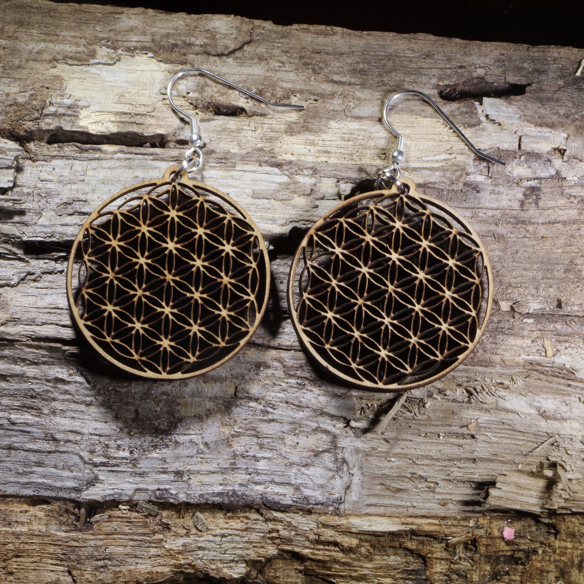 Handcrafted Flower of Life wooden dangle earrings featuring the sacred geometry symbol representing harmony, unity, and the interconnectedness of all life. Lightweight laser-cut wooden earrings with hypoallergenic .925 sterling silver hooks, perfect for yoga enthusiasts, meditation practitioners, spiritual jewelry lovers, reiki healers, and fans of sacred geometry.
