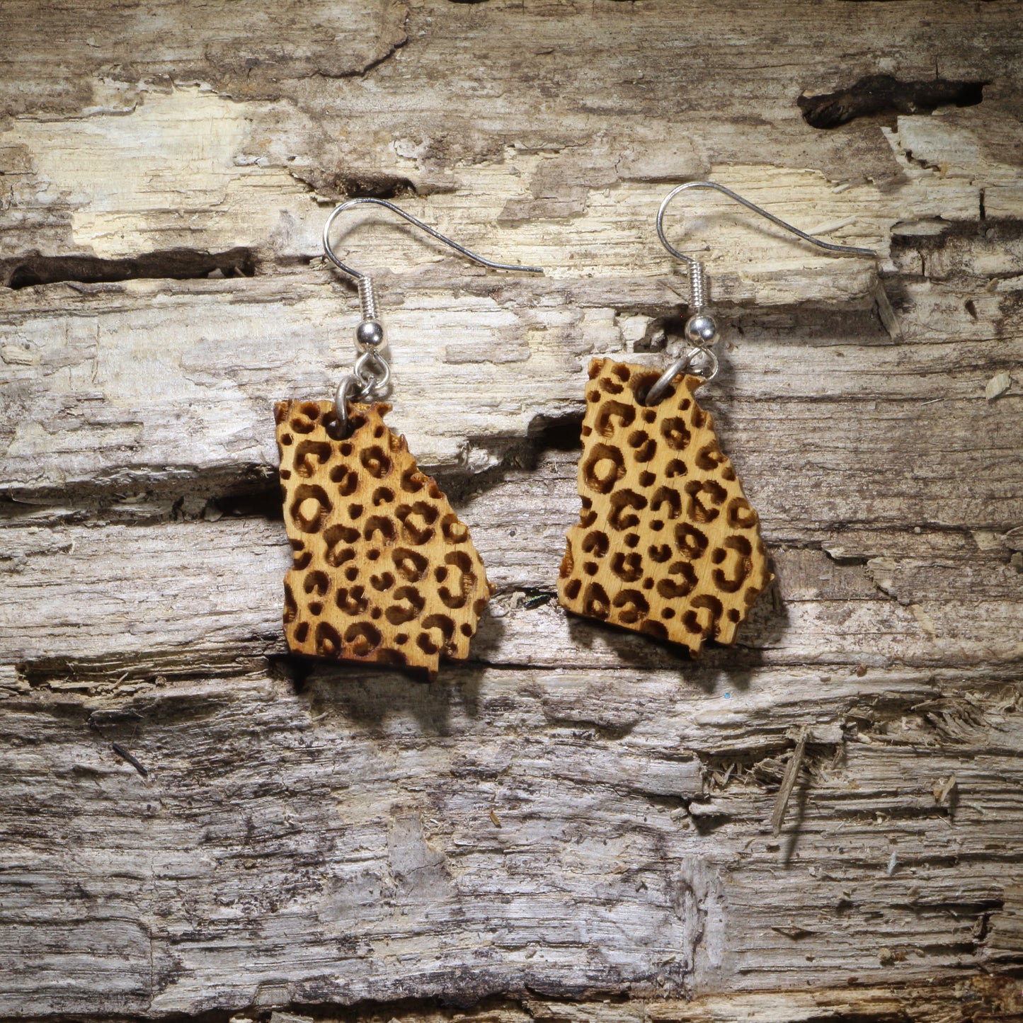 Handcrafted Georgia-shaped wooden dangle earrings featuring a stylish leopard print pattern. Lightweight laser-cut wooden earrings with hypoallergenic .925 sterling silver hooks, perfect for Georgia pride, Southern fashion, animal print lovers, hometown style, travel souvenirs, and unique handmade jewelry.