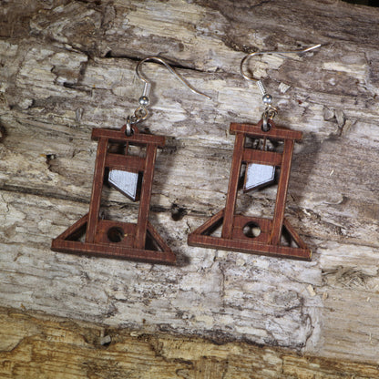 Hand-painted wooden guillotine dangle earrings featuring a detailed French Revolution guillotine design, hypoallergenic sterling silver hooks, and lightweight historical jewelry for history buffs, gothic fashion, and dark humor lovers by Cate’s Concepts.