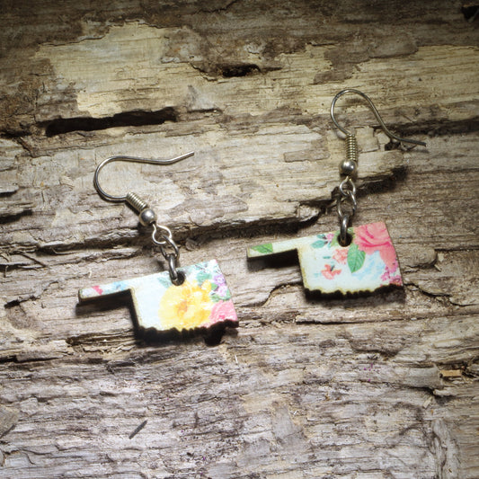 Hand-painted Floral Oklahoma wooden dangle earrings featuring the Oklahoma state silhouette accented with a colorful floral design. Lightweight and comfortable, these state pride earrings are perfect for Oklahoma natives, travelers, teachers, and anyone who loves showing off their Sooner State pride.