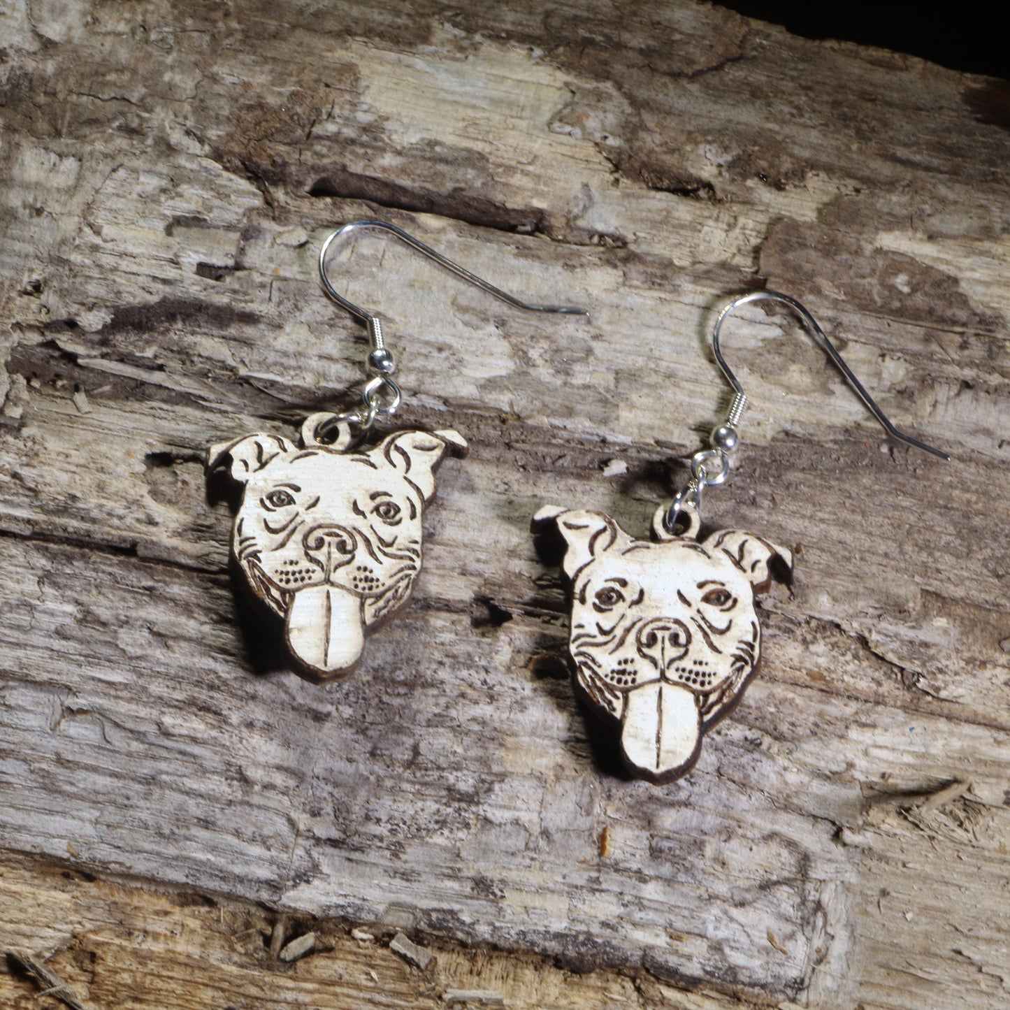 Hand-painted Pit Bull dog face wooden dangle earrings on hypoallergenic .925 sterling silver hooks. Lightweight Pit Bull jewelry featuring a happy Pit Bull with its tongue out, perfect for Pit Bull owners, rescue advocates, dog lovers, and bully breed enthusiasts.