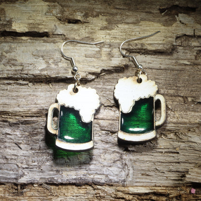 Hand-painted green beer mug wooden dangle earrings featuring frothy white foam and a rich green resin inlay. Lightweight beer lover jewelry perfect for St. Patrick’s Day celebrations, pub outings, festivals, and fun Irish-themed gifts.