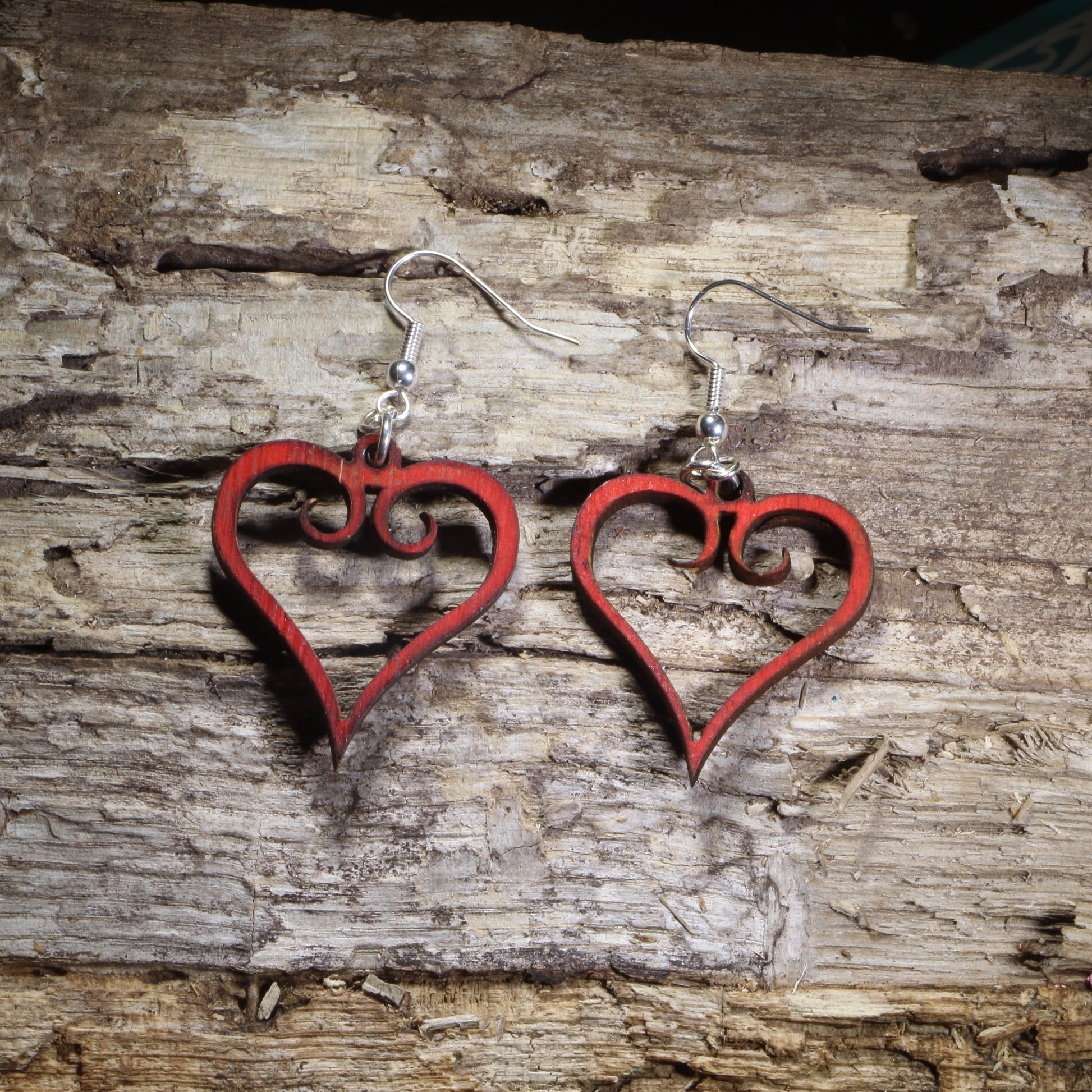 Hand-painted red wooden heart dangle earrings with an elegant open-heart scrollwork design on hypoallergenic .925 sterling silver hooks. Lightweight romantic jewelry perfect for Valentine's Day, anniversaries, weddings, date nights, or everyday heart-inspired style.