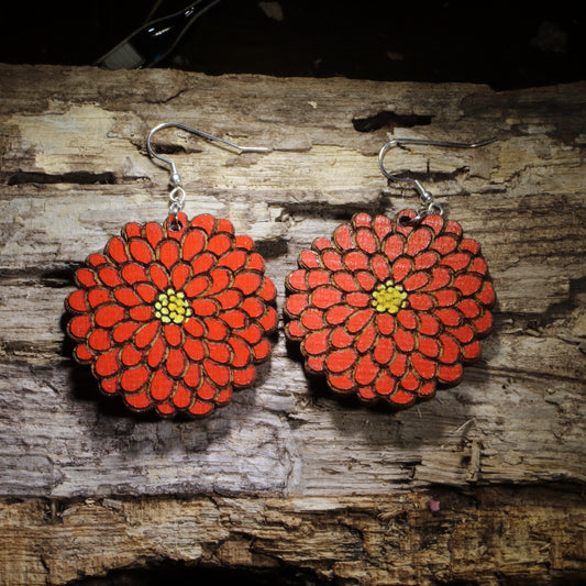 Hand-painted red zinnia wooden dangle earrings featuring a large layered flower design with detailed petals and yellow center. Lightweight floral earrings with hypoallergenic .925 sterling silver hooks, perfect for gardeners, flower lovers, nature enthusiasts, and botanical jewelry gifts.