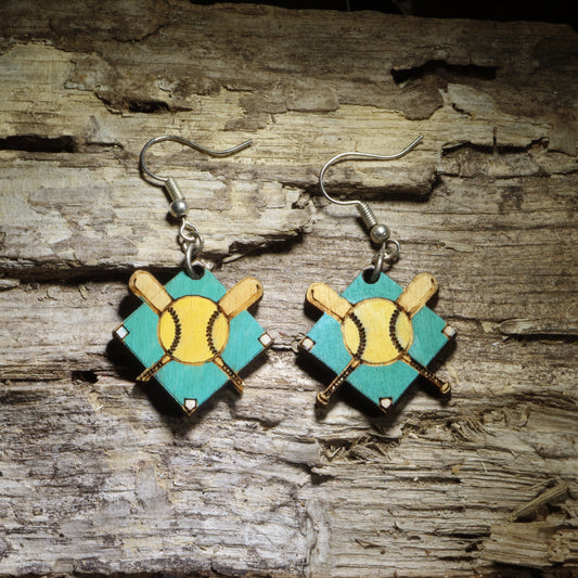 Hand-painted softball diamond wooden dangle earrings featuring a yellow softball, crossed bats, and a teal baseball field design. Lightweight sports earrings perfect for softball players, coaches, team moms, and softball fans.