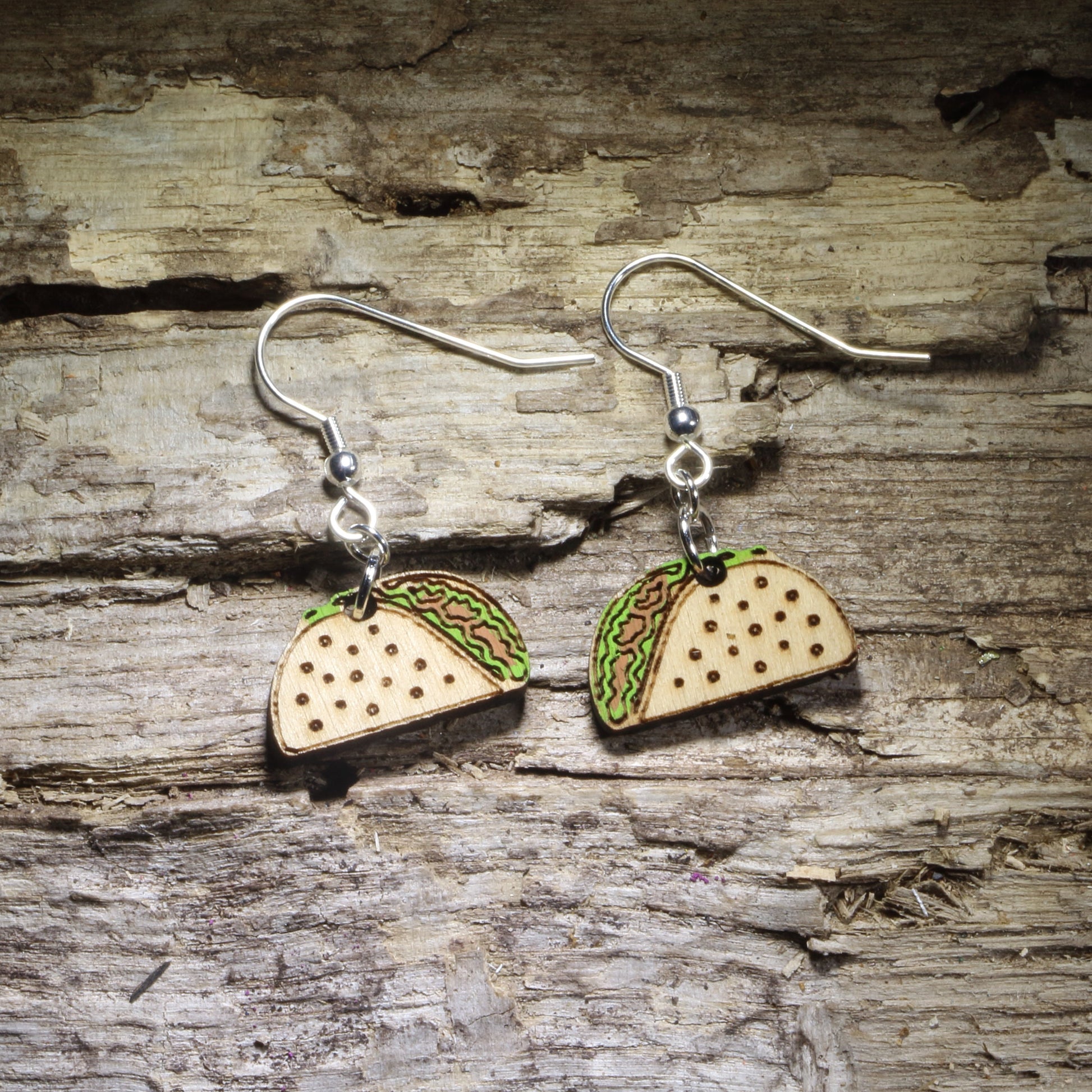 Hand-painted taco wooden dangle earrings featuring a crunchy taco shell filled with colorful lettuce and savory toppings. Lightweight food jewelry perfect for taco lovers, Taco Tuesday outfits, Mexican food fans, foodies, and fun culinary gifts.