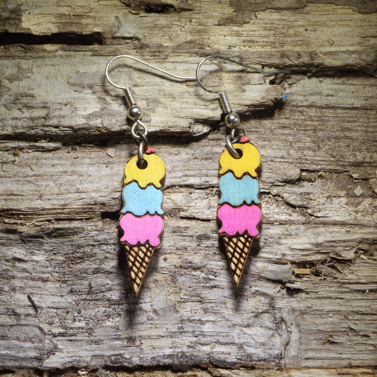 Hand-painted triple scoop ice cream cone wooden dangle earrings with yellow, blue, and pink scoops, colorful dessert jewelry for ice cream lovers
