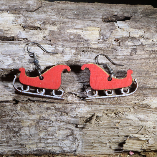 Hand-painted wooden Santa's sleigh dangle earrings with festive Christmas design. Lightweight holiday earrings featuring hypoallergenic .925 sterling silver hooks, perfect for Christmas parties, winter celebrations, and seasonal gifts.
