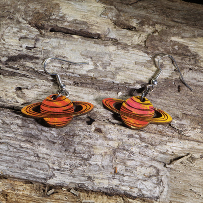 Hand-painted wooden Saturn planet dangle earrings featuring orange and gold striped rings on hypoallergenic .925 sterling silver hooks. Lightweight space-inspired jewelry for astronomy enthusiasts, science teachers, stargazers, NASA fans, and lovers of the solar system.