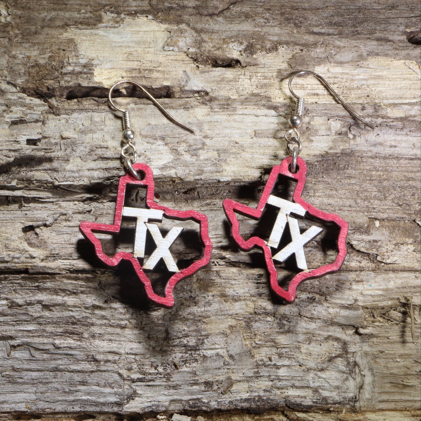 Hand-painted wooden Texas state dangle earrings featuring the Texas outline with a bold Texas flag design on hypoallergenic .925 sterling silver hooks. Lightweight Texas-themed jewelry for Texans, state pride, patriotic celebrations, travelers, and unique Texas gifts.