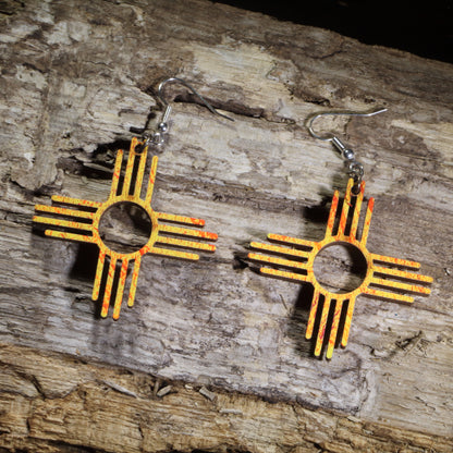 Hand-painted wooden Zia Sun symbol dangle earrings inspired by the New Mexico state symbol in vibrant orange and yellow on hypoallergenic .925 sterling silver hooks. Lightweight Southwestern jewelry perfect for New Mexico lovers, desert enthusiasts, and Southwest style.