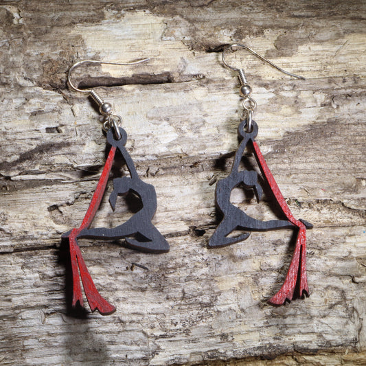 Hand-painted wooden aerial silks dangle earrings featuring an aerialist performing on red aerial silks with hypoallergenic .925 sterling silver hooks. Lightweight circus-inspired jewelry for aerialists, aerial yoga enthusiasts, gymnasts, dancers, circus performers, and acrobatics lovers.