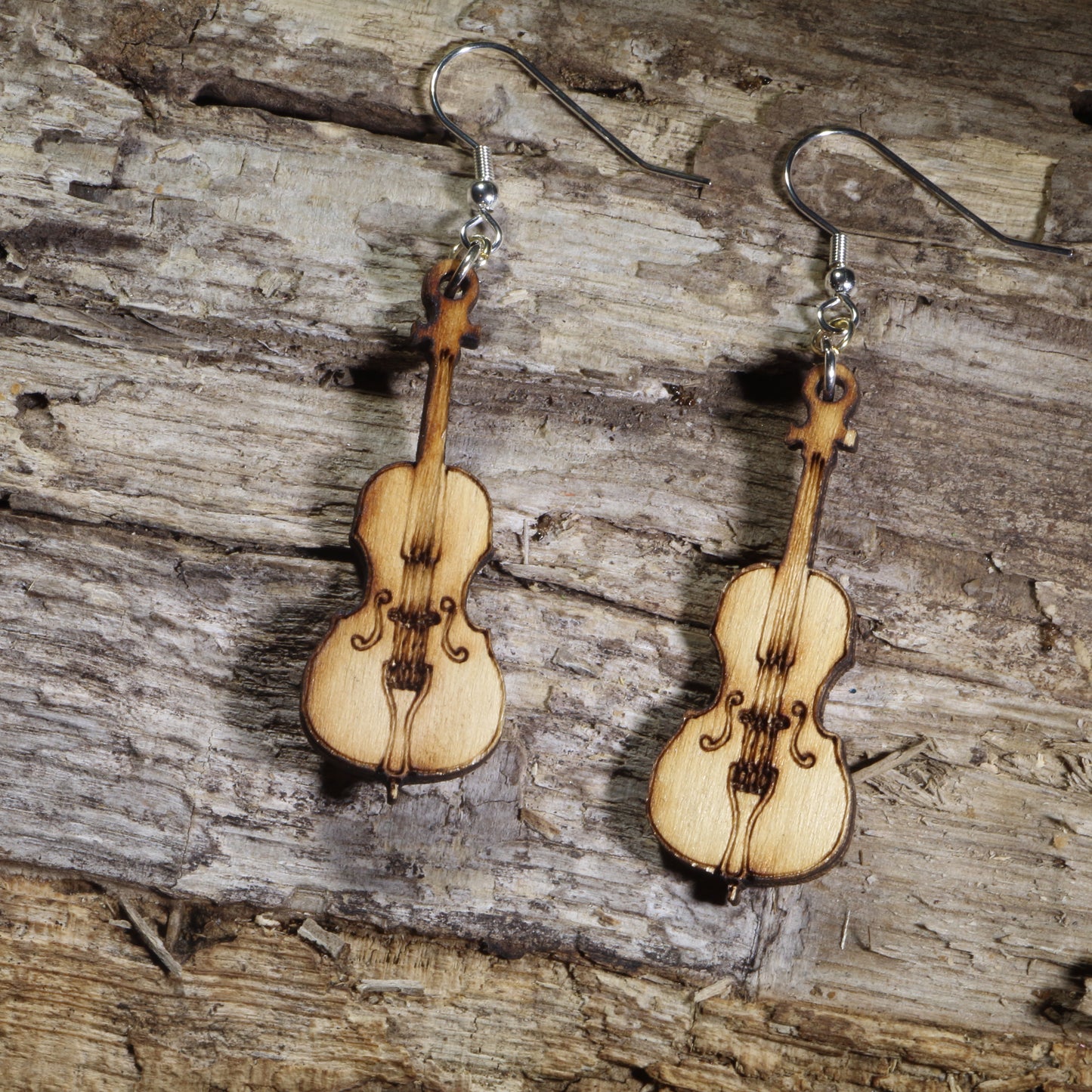 Hand-painted wooden cello dangle earrings with engraved strings and classic instrument details on hypoallergenic .925 sterling silver hooks. Lightweight orchestra jewelry perfect for cellists, string musicians, music teachers, and classical music lovers.