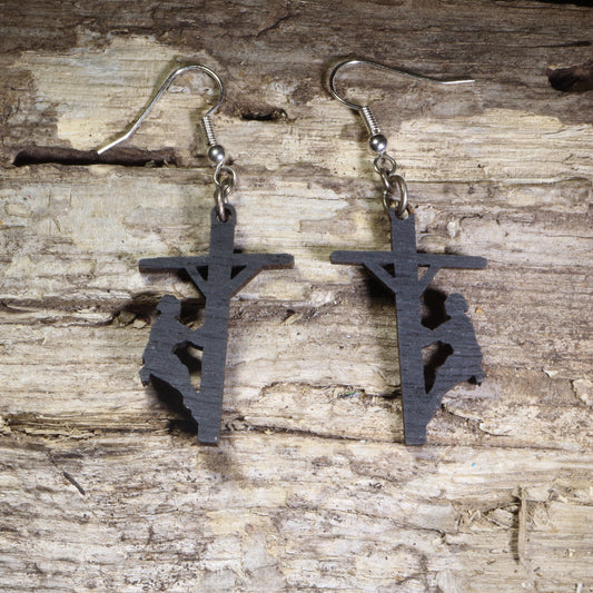 Hand-painted wooden lineman dangle earrings featuring a utility worker climbing a power pole silhouette on lightweight wood with hypoallergenic .925 sterling silver hooks. Perfect for linemen, electrical utility workers, power company employees, electricians, apprentices, and meaningful trade profession jewelry.