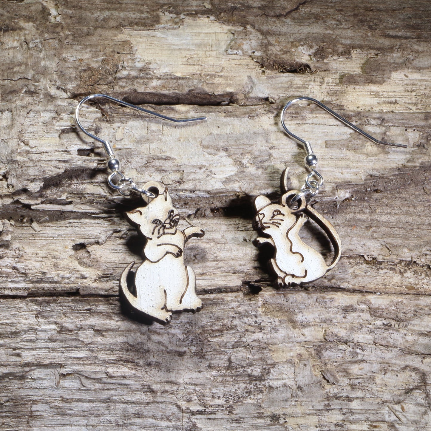 Hand-painted wooden mismatched cat and mouse dangle earrings featuring a playful white cat reaching toward a smiling mouse on hypoallergenic .925 sterling silver hooks. Lightweight animal jewelry for cat lovers, mouse enthusiasts, pet owners, and anyone who enjoys whimsical, playful accessories.