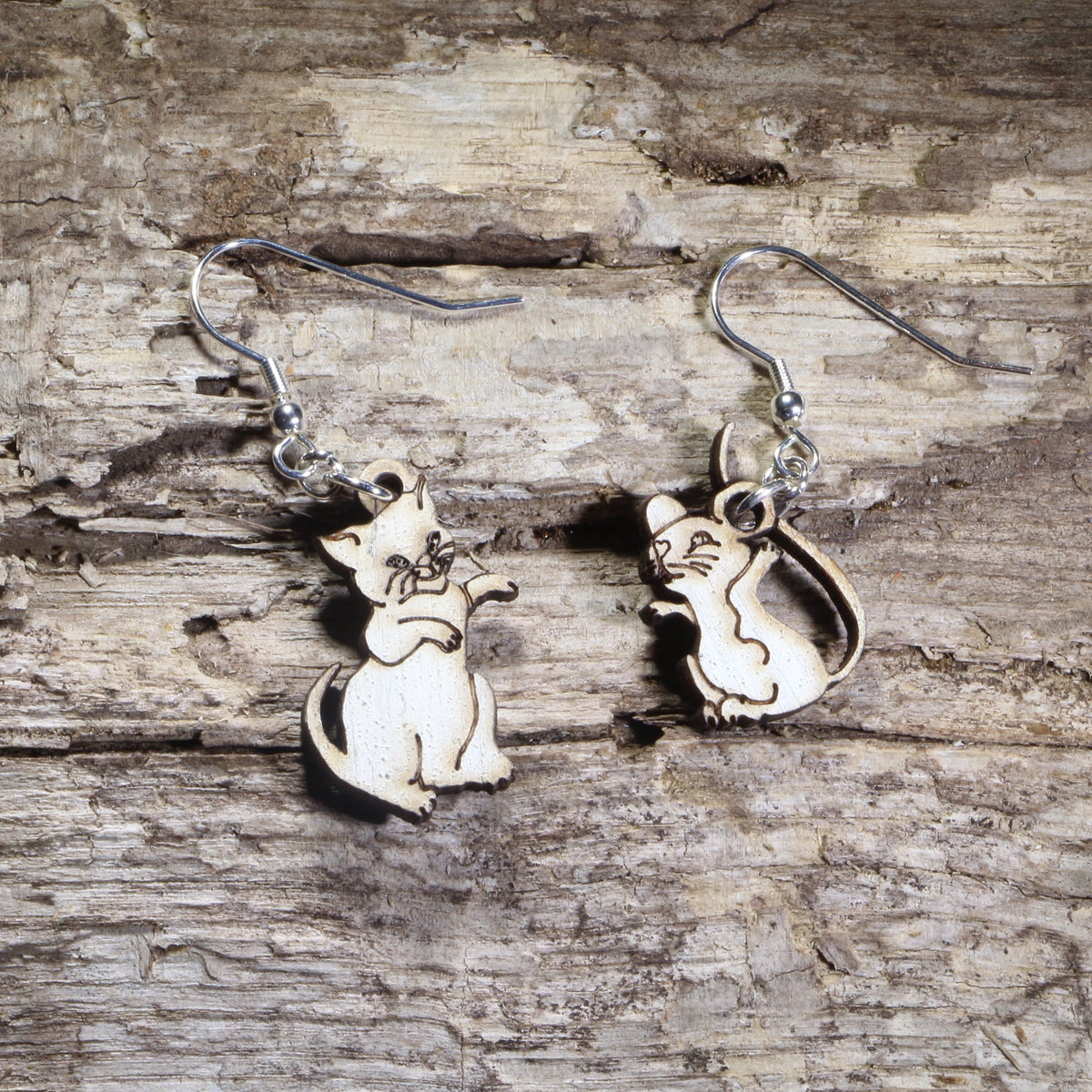 Hand-painted wooden mismatched cat and mouse dangle earrings featuring a playful white cat reaching toward a smiling mouse on hypoallergenic .925 sterling silver hooks. Lightweight animal jewelry for cat lovers, mouse enthusiasts, pet owners, and anyone who enjoys whimsical, playful accessories.
