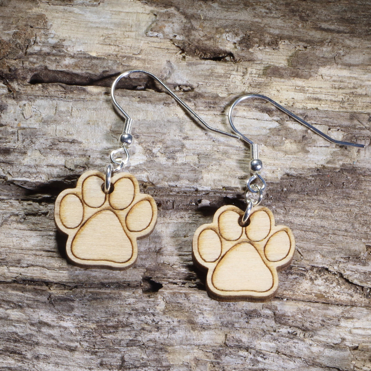 Hand-painted wooden paw print dangle earrings featuring engraved pet paw prints on hypoallergenic .925 sterling silver hooks. Lightweight pet lover jewelry for dog lovers, cat lovers, veterinarians, veterinary technicians, animal rescue supporters, and proud pet parents.