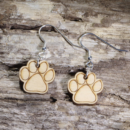 Hand-painted wooden paw print dangle earrings featuring engraved pet paw prints on hypoallergenic .925 sterling silver hooks. Lightweight pet lover jewelry for dog lovers, cat lovers, veterinarians, veterinary technicians, animal rescue supporters, and proud pet parents.