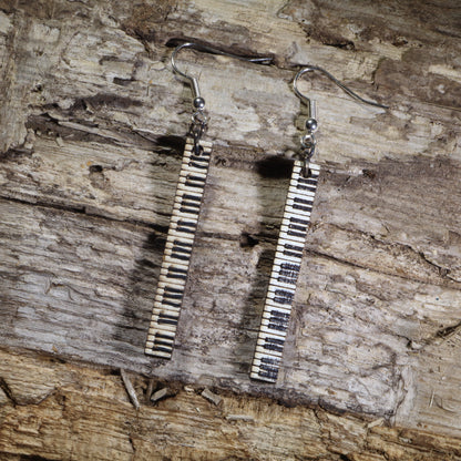 Hand-painted wooden piano keyboard bar dangle earrings featuring long vertical black and white piano keys on hypoallergenic .925 sterling silver hooks. Lightweight music jewelry perfect for pianists, piano teachers, music students, musicians, and classical music lovers.