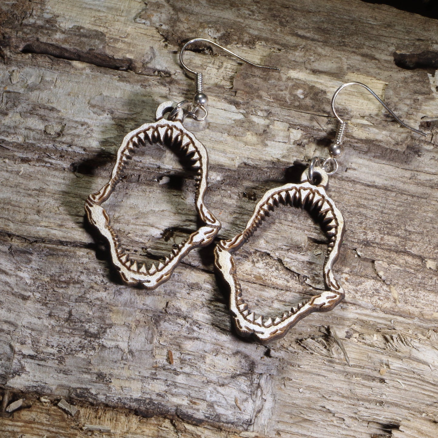 Hand-painted wooden shark jaw dangle earrings featuring detailed fossil-style shark jaws on hypoallergenic .925 sterling silver hooks. Lightweight ocean-inspired jewelry for shark lovers, marine biologists, beach enthusiasts, divers, and ocean wildlife fans.