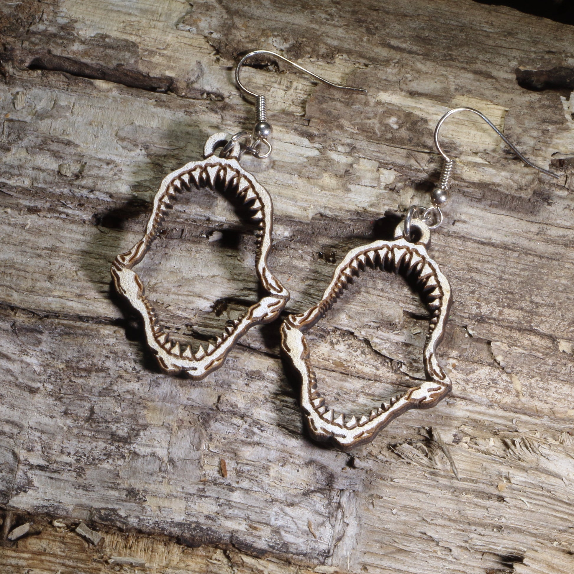 Hand-painted wooden shark jaw dangle earrings featuring detailed fossil-style shark jaws on hypoallergenic .925 sterling silver hooks. Lightweight ocean-inspired jewelry for shark lovers, marine biologists, beach enthusiasts, divers, and ocean wildlife fans.