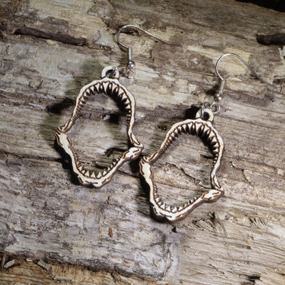 Hand-painted wooden shark jaw dangle earrings featuring detailed fossil-style shark jaws on hypoallergenic .925 sterling silver hooks. Lightweight ocean-inspired jewelry for shark lovers, marine biologists, beach enthusiasts, divers, and ocean wildlife fans.