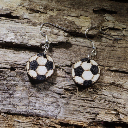 Hand-painted wooden soccer ball dangle earrings featuring the classic black-and-white soccer ball design. Lightweight sports earrings with hypoallergenic .925 sterling silver hooks, perfect for soccer players, coaches, referees, team moms, sports fans, and anyone who loves the world's favorite game.