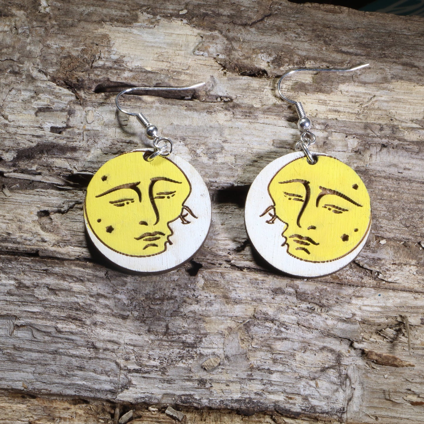 Hand-painted wooden sun and moon kissing dangle earrings featuring a vintage celestial design with the sun and crescent moon sharing a kiss on hypoallergenic .925 sterling silver hooks. Lightweight celestial jewelry for astronomy lovers, astrology enthusiasts, moon gazers, romantics, and fans of mystical and cosmic-inspired accessories.