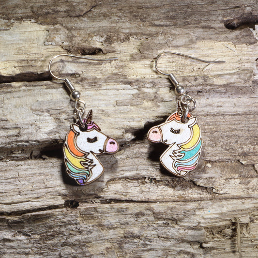 Hand-painted wooden unicorn head dangle earrings featuring a white unicorn with a rainbow mane and gold horn on hypoallergenic .925 sterling silver hooks. Lightweight fantasy-inspired jewelry for unicorn lovers, magical creature fans, colorful accessory collectors, and whimsical gift giving.