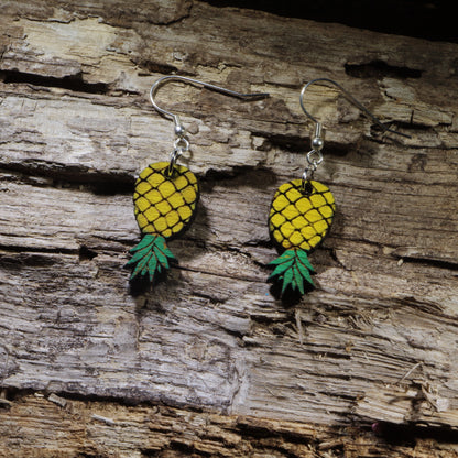 Hand-painted wooden upside-down pineapple dangle earrings featuring the iconic upside-down pineapple symbol in vibrant yellow and green. Lightweight wooden earrings with hypoallergenic .925 sterling silver hooks, perfect for tropical style, cruise vacations, beach lovers, and playful conversation-starting accessories.