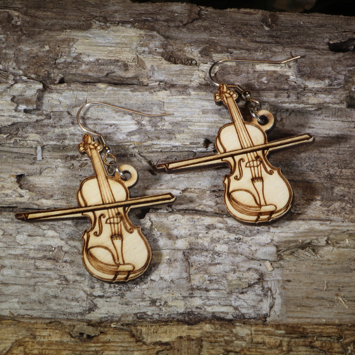 Hand-painted wooden violin and bow dangle earrings featuring an engraved classical string instrument design on hypoallergenic .925 sterling silver hooks. Lightweight music-inspired jewelry for violinists, orchestra members, music teachers, string students, and classical music lovers.